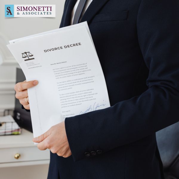 A Hicksville divorce lawyer in a suit holds a document titled "Divorce Decree" in an office, with the Simonetti & Associates logo visible in the top left corner.