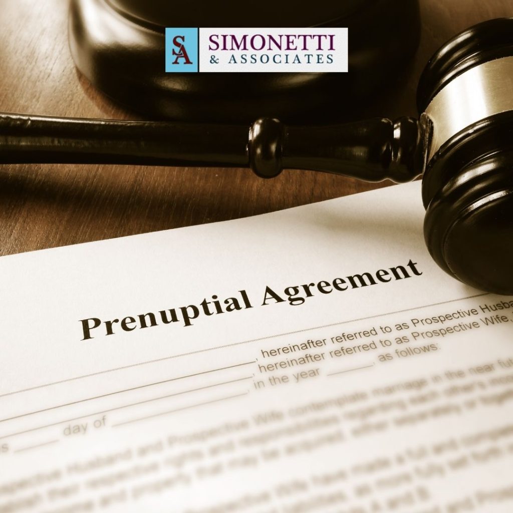 A prenuptial agreement document sits on a table beside a judge's gavel, with a Simonetti & Associates logo in the background, highlighting the expertise of a Hicksville Divorce Lawyer.